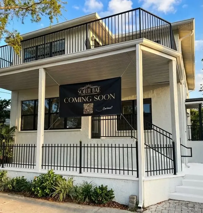 The Sober Bar's white two-story building in Gulfport, Florida, with its Coming Soon banner